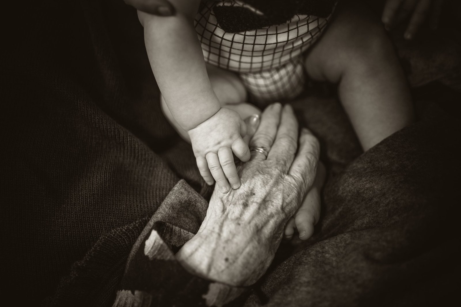 The Four Stages of Elimination,an older woman holding a baby's hand