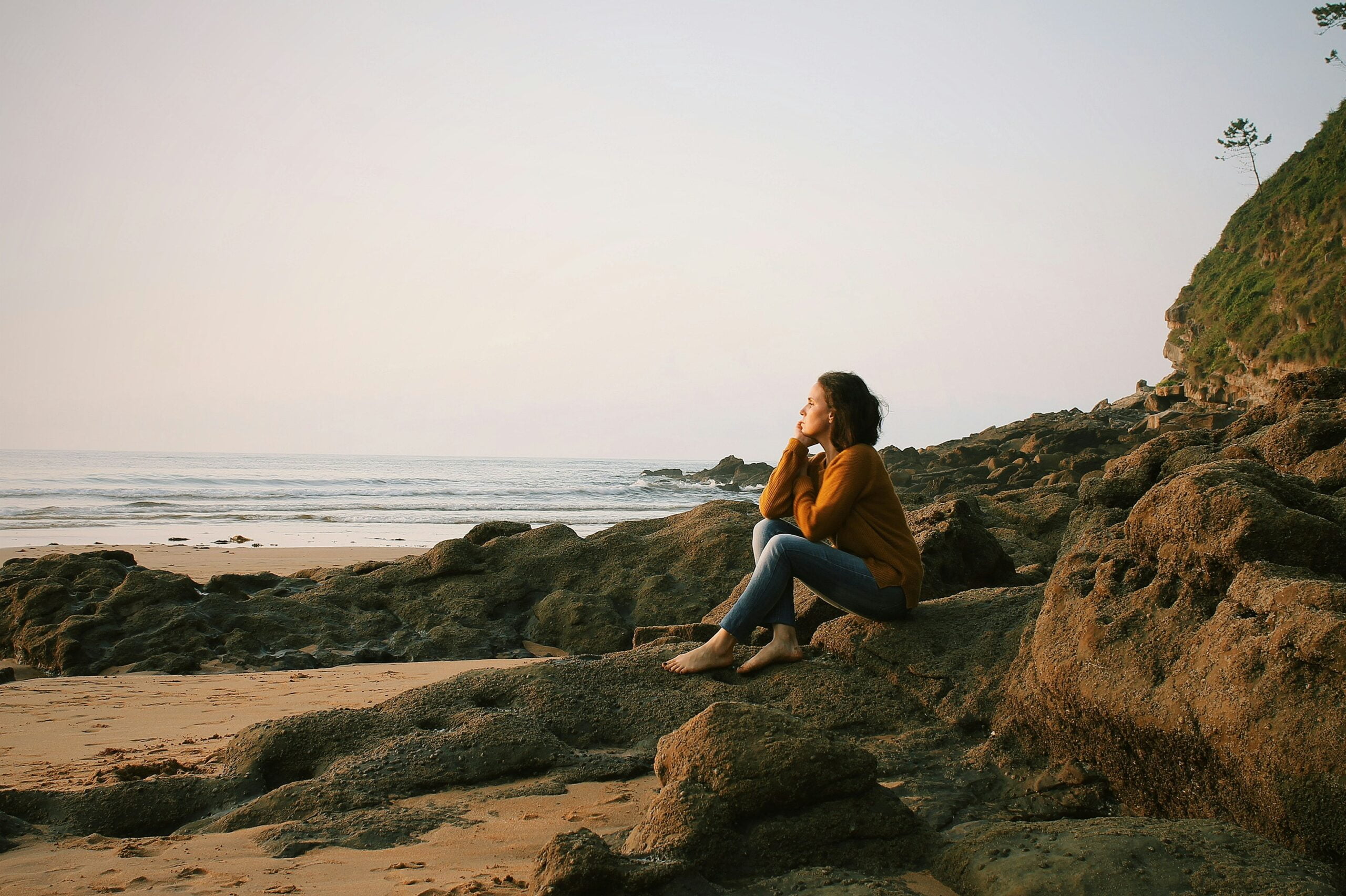 Thoughts, woman sitting near sea during daytime