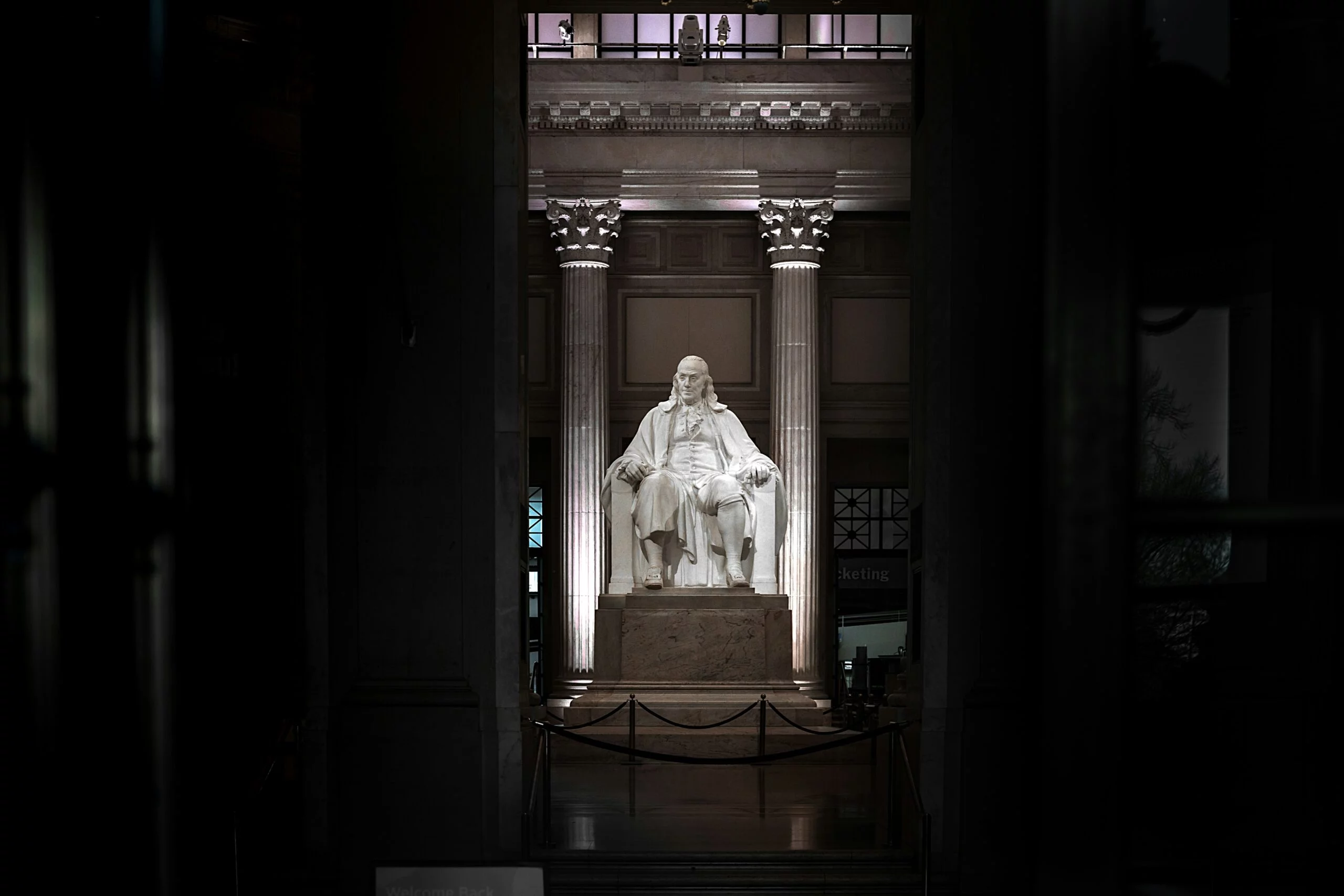 Benjamin Franklin's Thirteen Virtues, white concrete statue on brown wooden table