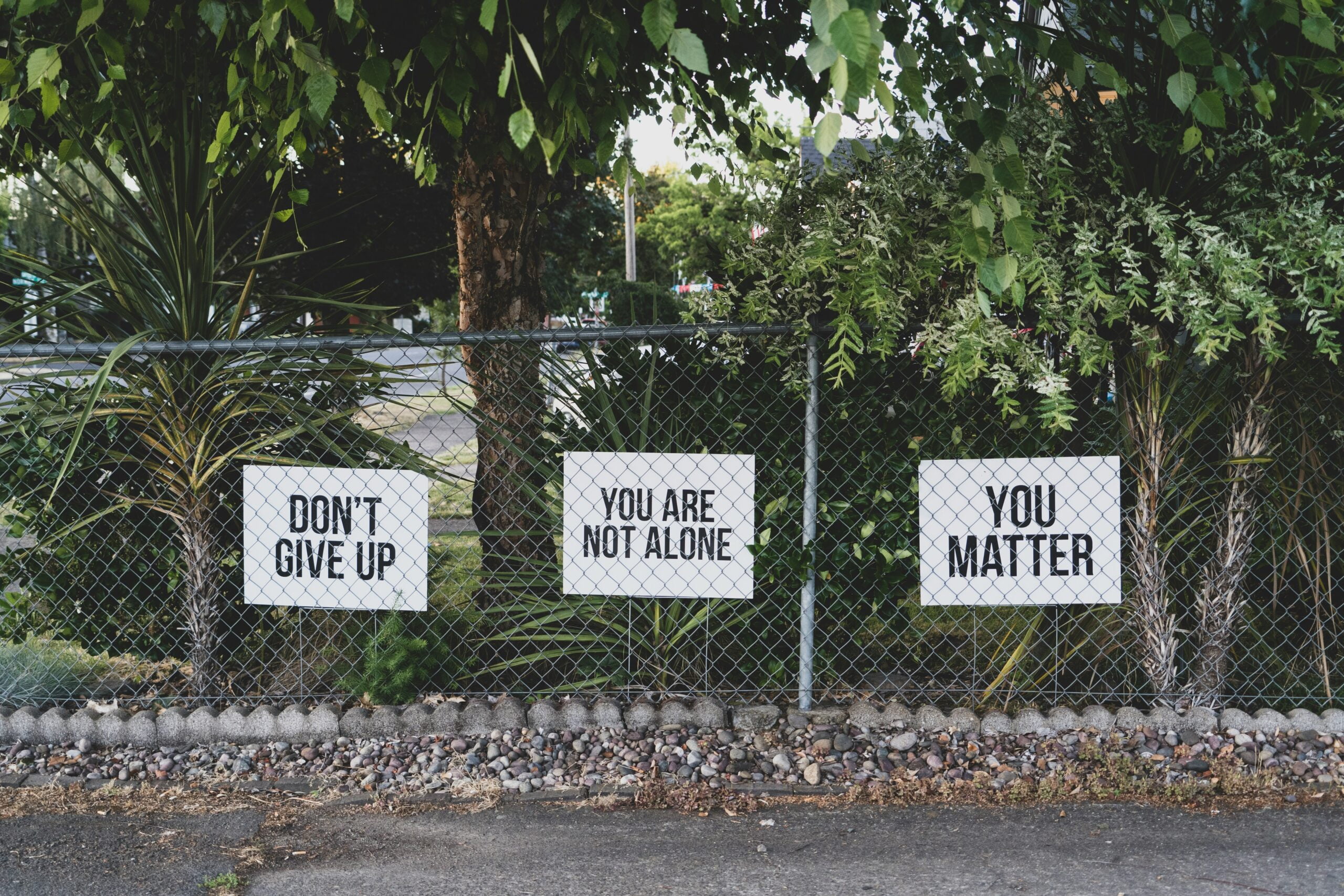 anxiety, don't give up. You are not alone, you matter signage on metal fence
