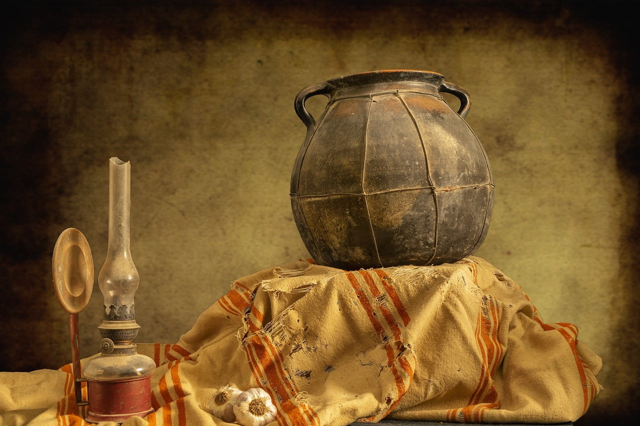 a clay pot on a cloth and a kerosene lamp,End of Life